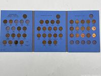 Full view of three blue coin album pages with Canadian small cent coins inserted, showing dates from 1920 to 1966 under George V, George VI, and Elizabeth II reigns.