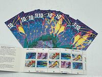 Folded opened booklet showing 10 stamps of 42 cents each with Winter Olympic sports graphics.