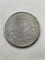 Reverse side of the 1921 S Morgan silver dollar showing eagle with wings spread and inscriptions.