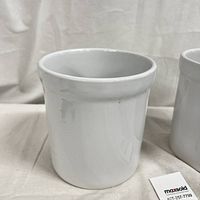 White ceramic kitchen utensil holder on fabric background showing size and condition
