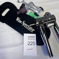 Two wine openers and accessories with Wine Spectator fabric carrying case, showing whole lot and label