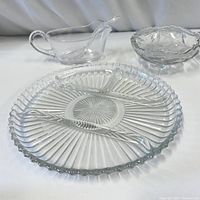 Set of three cut glass dishes displayed on a white surface.