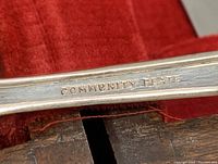 Close-up of 'Community Plate' engraving on a fork handle to identify brand