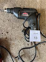 Full view of black Jobmate corded drill with power cable showing overall condition and design.