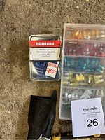 Photo of HomePak pack of vinyl insulated butt connectors and a black wristwatch strap visible below along with yellow handled hand tools and plastic fuse box