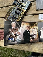 Photo of the open James Bond 50 DVD box set showing a booklet with images of various actors who have played James Bond.