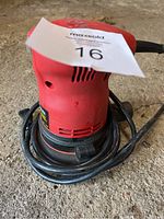 Front and top view of King Canada corded random orbit sander, power cord coiled at base, placed on concrete ground with auction tag on top.