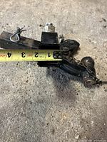Close-up of tape measure across the horizontal tube of the larger trailer hitch showing width approximately 2 3/4 inches