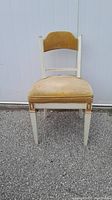 Front view of vintage desk chair with cream frame and mustard velvet seat and backrest shows design and condition.