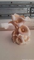 Front view of vintage beige orchid candle holder sculpture showing clustered flowers with curling petals