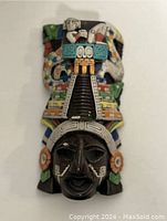 Front view of the colorful Aztec wall hanging with detailed face and intricate patterns.