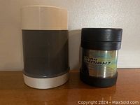 Front view of two thermoses, one large gray and white, one small Dark Knight design.