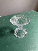 Top view of the wide upper tier showing etched fern-like design on clear crystal