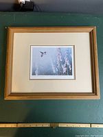 Photo of the entire framed print showing the wooden frame and matting around the art.