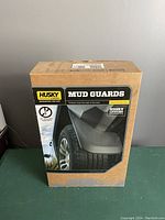 Box of Husky Liners Mud Guards showing the front packaging with product image and brand logo.