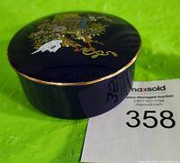 Cobalt blue round trinket box with a lid featuring a detailed floral and Japanese scene design with gold trim.