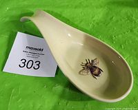 Image showing the front of the ceramic spoon holder with bumble bee design inside.