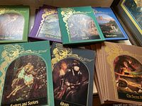 Flat lay of front covers showing Seekers and Saviors, Ghosts, The Secret Arts and others