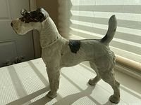 Side profile of the wire-haired Fox Terrier door stop showing full body and tail position.
