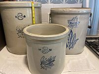 Front view of all three crocks showing 3, 6 and 8 gallon markings and logos