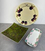 Set of three ceramic platters displayed together, showing different shapes and designs.