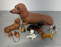 Full view of all 9 dog figurines showing variety of sizes and colors.