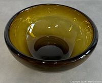 Top view showing the smooth interior and amber color gradient of the glass bowl.