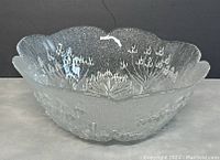 Front angled view of clear glass bowl with Cow Parsley floral pattern and scalloped edge