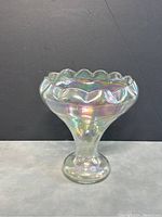 Side view of vintage iridescent carnival glass vase showing shape and ruffled rim