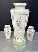 Photo showing all four items: three Candal ceramic vases with floral designs and one green ceramic trinket box with raised floral/bow decor on lid.