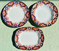 Photo of three antique Royal Crown Derby Imari porcelain pieces: two round plates and one rectangular platter, showing top view highlighting colors and pattern.