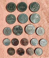 Photo showing multiple old Canadian coins including dollar coins from 1877, 1965 and confederation commemoratives.