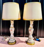 Pair of vintage Limoges porcelain lamps with original shades, white porcelain with floral and gold accents, brass bases, pull-chain switches