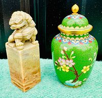 Photo showing the front side of the soapstone seal with foo dog and the cloisonné vase featuring a detailed floral design on green.