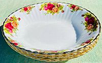Stack of 3 oval bone china serving bowls showing floral rose pattern and gold-edged scalloped rims.