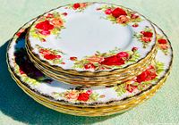 Stack of Royal Albert Old Country Roses plates showing floral pattern and gold edges