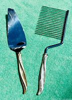 Full view of the vintage cake slicer and server set showing the sterling silver handles and the stainless steel blades.