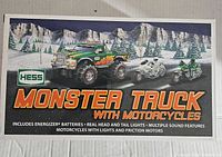 Box front showing Hess Monster Truck with Motorcycles with snowy mountain background, branding, and product features text