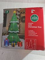 Box showing brand, size 8 ft, LED lights, indoor/outdoor, includes ground stakes