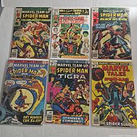 Front covers of six vintage Marvel Team-Up and Marvel Tales Spider-Man comic books featuring Yellowjacket, Wasp, Devil-Slayer, Black Widow, Human Torch, Tigra, and Spider Slayer.