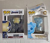Front view of boxed Avengers Endgame Rescue and Harry Potter Patronus Ron Weasley Funko figures.