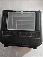 Closed Black & Decker Firestorm carrying case, black plastic, showing branding on top.