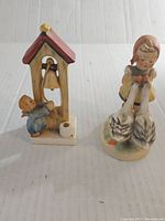 Both vintage Hummel figurines side by side, showing scale and condition.