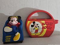 Both radios side by side; blue Mickey lounging radio on left, red portable radio on right