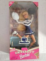 Front view of the Penn State University Barbie doll in original packaging showing doll in cheerleader uniform holding pom-poms, with some box wear visible