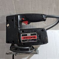 Side view showing Craftsman label and saw body with textured grip.