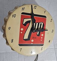 Front view of the vintage 7 Up plastic bottle cap clock showing the logo, clock face and hands.