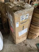 Box of McLean air conditioner showing label with model and handling instructions