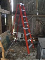 Full view of the orange fibreglass step ladder standing upright in a wooden shed, showing the entire ladder and structure.