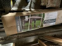 Long cardboard box showing Uberhaus branding and gazebo image on packaging